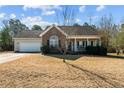Inviting one-story home featuring a brick facade, neutral siding, and a covered front porch at 59 Claymore Ct, Broadway, NC 27505