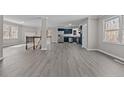 Open concept living room with gray walls, flooring and a view of the kitchen at 9349 Perry Rd, Graham, NC 27253