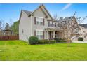 Well-maintained two-story home with lush green lawn, mature tree, and charming curb appeal at 103 Coopers Creek Ave, Spring Lake, NC 28390