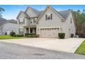 A well-maintained two story home with an attached two car garage and a large driveway at 103 Coopers Creek Ave, Spring Lake, NC 28390