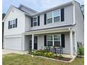 Charming two-story home with a seating area on the front porch at 15 Summerwood Ln, Lillington, NC 27546