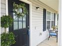 Close up of the front door with a decorative wreath and seating area at 15 Summerwood Ln, Lillington, NC 27546