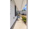 Cozy front porch with seating, plants, and a view of the side yard at 15 Summerwood Ln, Lillington, NC 27546