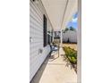 Cozy front porch with chairs and flower bed, great for relaxing outdoors at 15 Summerwood Ln, Lillington, NC 27546