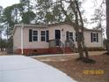 Inviting single-story home with a brick foundation, dark shutters, and a well-kept lawn at 162 Deer Vw, Sanford, NC 27332
