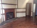 Inviting living room featuring a cozy fireplace and built-in shelves, great for entertaining at 165 Brent Wood, Sanford, NC 27332