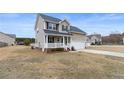 Inviting two-story home with a covered front porch and spacious yard at 24 Emma Ct, Linden, NC 28356