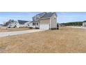 Two-story home with a two-car garage and a well-manicured lawn at 24 Emma Ct, Linden, NC 28356