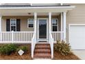 Welcoming front porch with brick steps and white railing leading to front door at 24 Emma Ct, Linden, NC 28356
