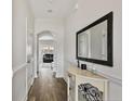 Bright entryway with hardwood floors, decorative mirror, and doorway to the living area at 28 Coswell Ct, Cameron, NC 28326