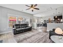 Comfortable living room with large windows, neutral tones, and an open layout leading to the dining area at 28 Coswell Ct, Cameron, NC 28326