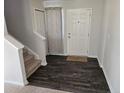 Inviting foyer with dark wood floors, white walls and trim, and carpeted stairs at 280 Hallow Oak Dr, Spring Lake, NC 28390
