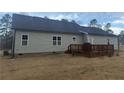 Exterior shot showcasing a rear wooden deck for outdoor enjoyment at 4271 Mcdougald Rd, Lillington, NC 27546