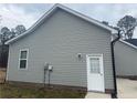 Side view of house showing neutral vinyl siding and access door at 4271 Mcdougald Rd, Lillington, NC 27546