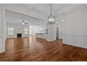 Bright open-concept living space with hardwood floors, fireplace, and open to the modern kitchen at 45 Glen Bend Ct, Spring Lake, NC 28390