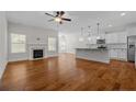 Open-concept living room featuring a fireplace, hardwood floors, and lots of natural light at 45 Glen Bend Ct, Spring Lake, NC 28390
