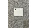 Close-up of neutral toned carpet swatch with a white color sample on top at 46 Pikewood Ct, Lillington, NC 27546