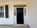 Elegant black front door with white trim and sidelights, offering a welcoming entrance to the home at 46 Pikewood Ct, Lillington, NC 27546