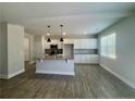 Modern kitchen with gray cabinets, granite countertops, stainless steel appliances, and wood-look floors at 46 Pikewood Ct, Lillington, NC 27546