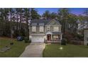 Beautiful two-story home with a manicured lawn, inviting porch, and attached garage at 63 Slate Dr, Spring Lake, NC 28390