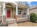 Inviting front porch with stone accents, rocking chairs, and a warm, welcoming feel at 63 Slate Dr, Spring Lake, NC 28390