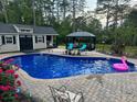 Inviting backyard pool area with a gazebo, shed, and lounge chairs at 105 Lakewood Vw, Sanford, NC 27332