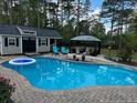 Backyard pool featuring a gazebo, storage shed, and lounge chairs at 105 Lakewood Vw, Sanford, NC 27332