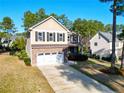 Two-story home with stone accents, a two-car garage, and a long driveway in a landscaped neighborhood at 207 Heather Brook Cir, Spring Lake, NC 28390