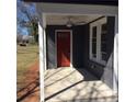 Front porch with red painted front door and ceiling fan at 311 Saunders St, Sanford, NC 27330