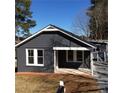 Charming single story home features a modern color palette and a well-maintained front yard at 311 Saunders St, Sanford, NC 27330