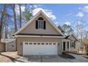 Attached two-car garage shows a home with a finished front exterior and driveway at 6090 Dunes Dr, Sanford, NC 27332