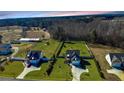 Aerial view of two homes with spacious green yards in a rural, wooded setting at 126 Dry Creek Rd, Lillington, NC 27546