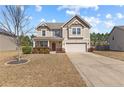 Inviting two-story home showcasing a neat front yard and convenient two-car garage at 251 Crane Way, Bunnlevel, NC 28323