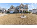 Traditional two-story home featuring a well-maintained lawn at 30 Yaupon Cir, Spring Lake, NC 28390