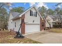 Side view of home featuring two car garage and brick and siding details at 33 Woodbury Ln, Sanford, NC 27332