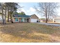 Spacious front yard showcasing a well-maintained single story home with ample space at 639 Riverwind Dr, Spring Lake, NC 28390