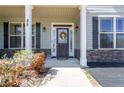 Inviting front entrance with decorative wreath and beautiful stone accents at 85 Clearview Ct, Sanford, NC 27332