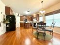 Eat-in kitchen with wood cabinetry, sleek appliances, island, and bright natural light at 85 Clearview Ct, Sanford, NC 27332