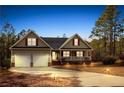 Charming single-Gathering home featuring a two-car garage, welcoming porch, and beautifully landscaped front yard at 15 Clearwater Hbr, Sanford, NC 27332