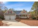 Charming single-Gathering home featuring a two-car garage, welcoming porch, and beautifully landscaped front yard at 15 Clearwater Hbr, Sanford, NC 27332