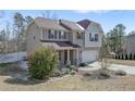 Traditional two-story home with a blend of stone and siding, set in a landscaped yard at 451 Colonist Pl, Cameron, NC 28326