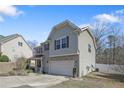 Angle view of a beautiful home featuring stone and siding, complemented by a well-maintained lawn at 451 Colonist Pl, Cameron, NC 28326