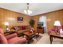 Spacious living room with comfortable seating, wood-paneled walls, and ample space for entertaining at 148 Manchester Dr, Goldston, NC 27252