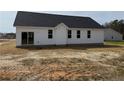 Exterior back view of the home with white siding and windows, ready for landscaping at 164 Jones Creek Ln, Lillington, NC 27546