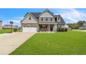 Charming two-story home with a combination of stone and siding, complemented by a well-manicured lawn at 18 Harvest Cts, Linden, NC 28356