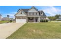 Charming two-story home with a combination of stone and siding, complemented by a well-manicured lawn at 18 Harvest Cts, Linden, NC 28356