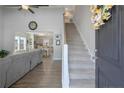 Bright foyer with wood floors, open staircase, and view of the living area and kitchen at 268 Kensington Dr, Spring Lake, NC 28390