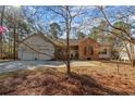 Charming home featuring a two-car garage, brick accents, and beautiful natural landscaping at 51 Cedar Ln, Sanford, NC 27332