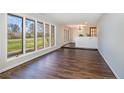 Spacious living room with hardwood floors, large windows, and a neutral color palette at 1010 Henley Rd, Sanford, NC 27330