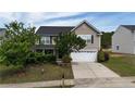 Two-story home with attached garage, landscaping, and covered porch, offering a classic suburban aesthetic at 126 Thimbleweed Dr, Lillington, NC 27546